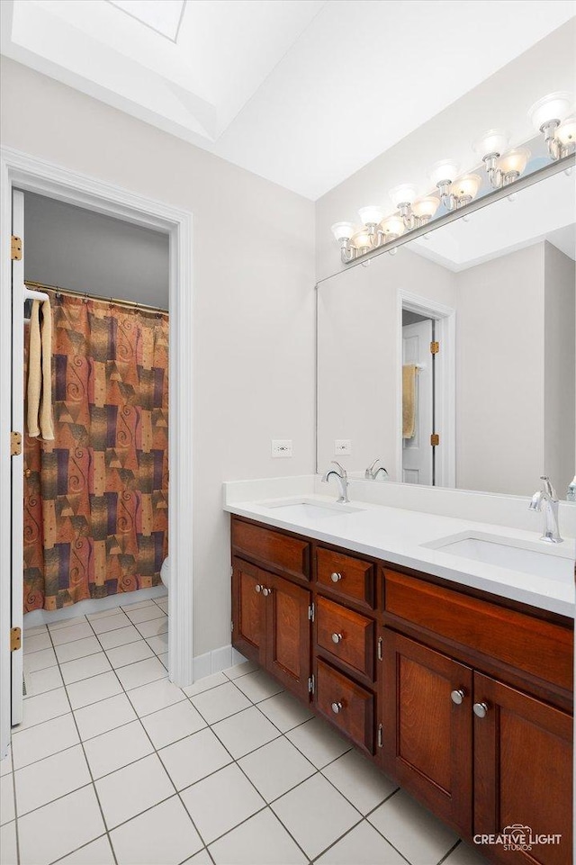 bathroom with tile patterned floors and vanity