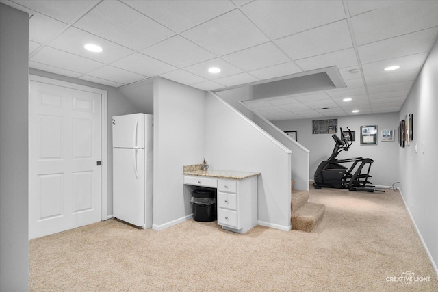 interior space with white refrigerator, a paneled ceiling, and light colored carpet