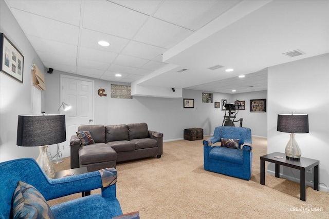 living room featuring a paneled ceiling and light carpet