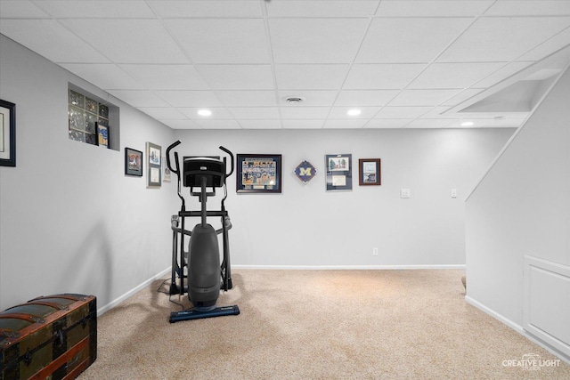 exercise room with carpet floors and a drop ceiling