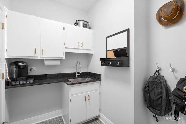 kitchen featuring sink and white cabinetry