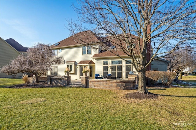 rear view of house featuring a yard