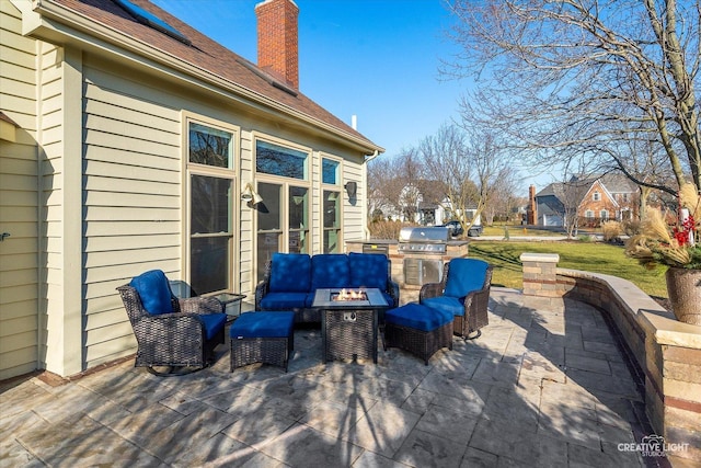 view of patio / terrace featuring exterior kitchen, area for grilling, and an outdoor living space