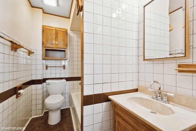 bathroom with tile walls, toilet, tile patterned floors, a bathtub, and vanity