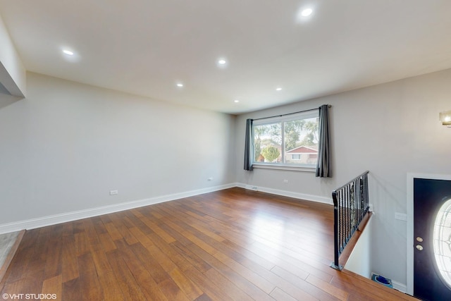 unfurnished living room with dark hardwood / wood-style flooring