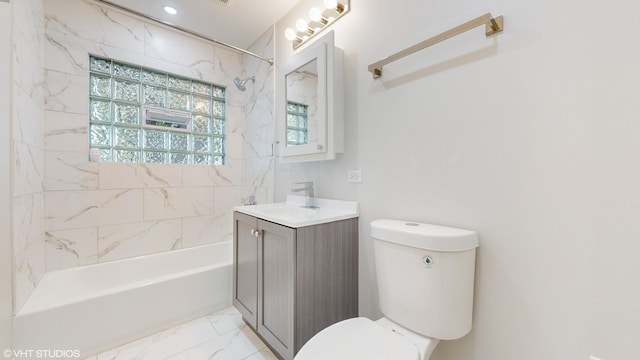 full bathroom with toilet, vanity, and tiled shower / bath