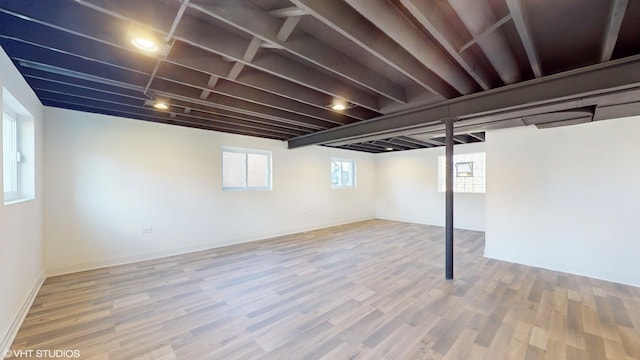 basement with hardwood / wood-style flooring