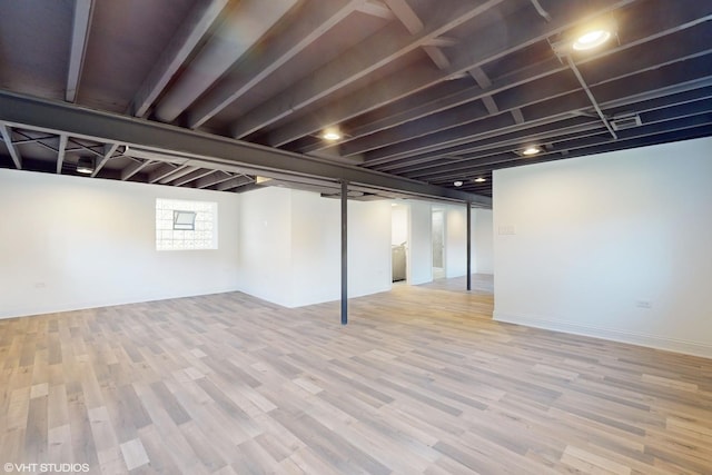 basement with light hardwood / wood-style floors