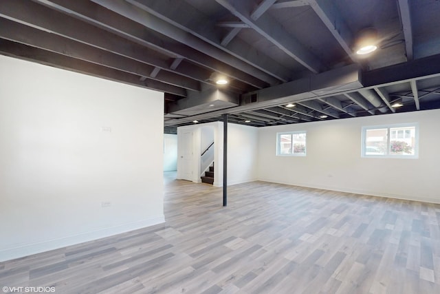 basement with hardwood / wood-style flooring