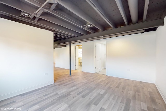 basement featuring light hardwood / wood-style floors