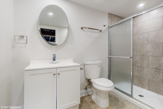 bathroom featuring toilet, an enclosed shower, vanity, and tile patterned flooring