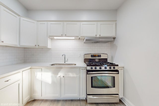 kitchen featuring sink, white cabinets, and stainless steel gas range oven