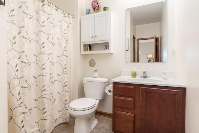 bathroom with toilet, vanity, tile patterned flooring, and a shower with curtain