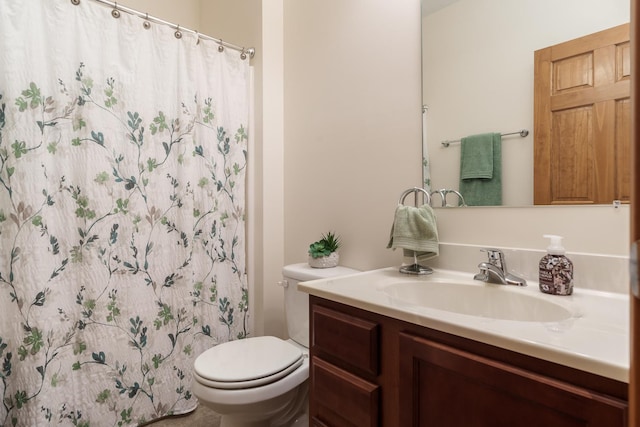 bathroom featuring toilet, a shower with shower curtain, and vanity