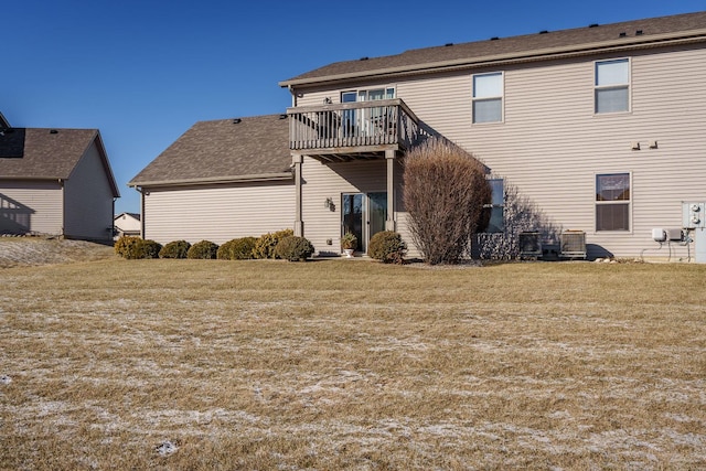 back of house with a lawn, cooling unit, and a balcony