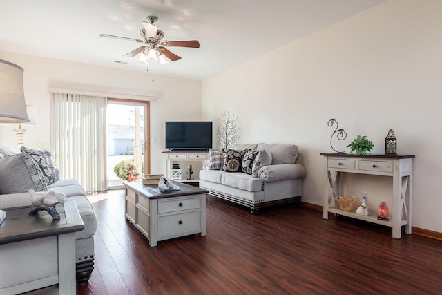 living room with ceiling fan and dark hardwood / wood-style flooring