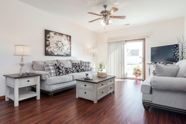 living room with ceiling fan and dark hardwood / wood-style floors