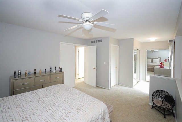 bedroom with ceiling fan and light carpet