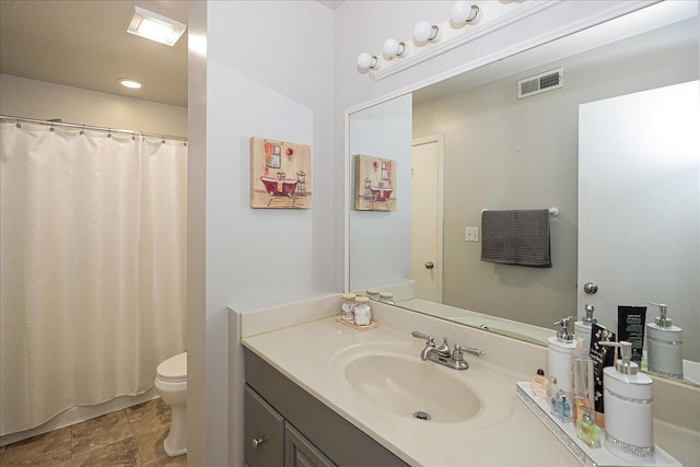 bathroom featuring toilet and vanity