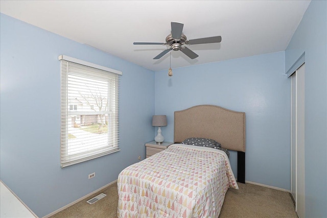 bedroom with ceiling fan and light carpet