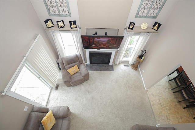 carpeted living room featuring a fireplace