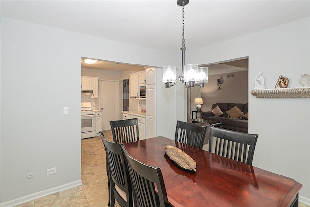 dining space featuring an inviting chandelier