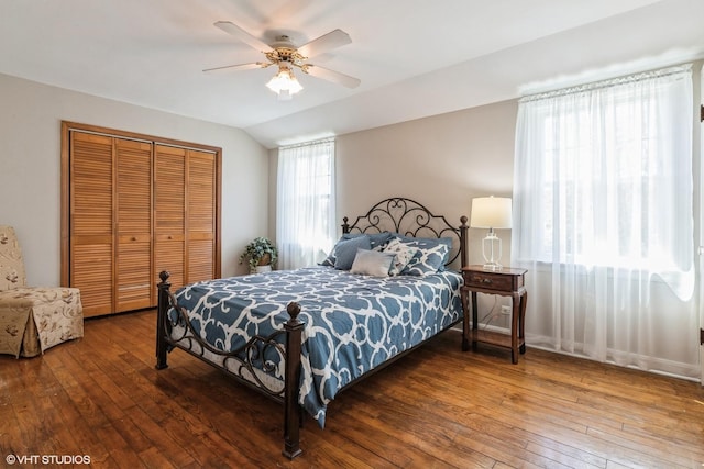 bedroom with vaulted ceiling, ceiling fan, a closet, and wood-type flooring