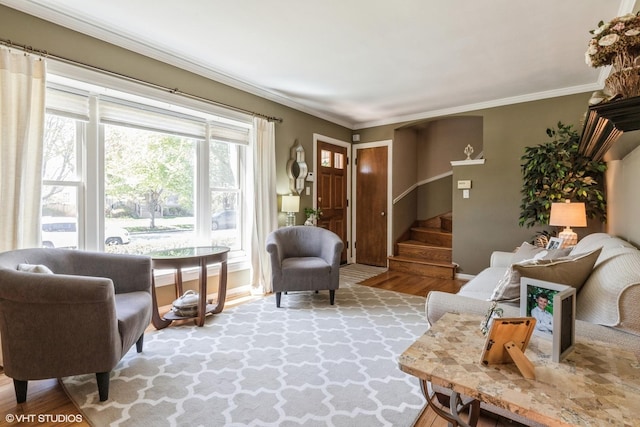 living area with ornamental molding and wood-type flooring