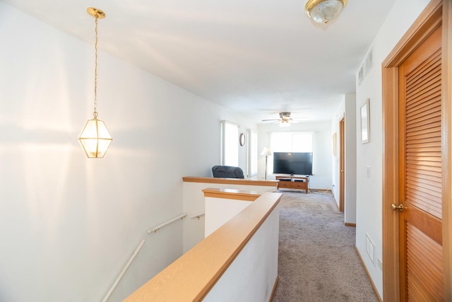 corridor with light colored carpet