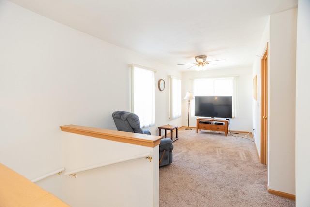 carpeted living room featuring ceiling fan