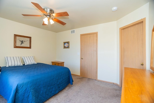 bedroom with ceiling fan and light colored carpet