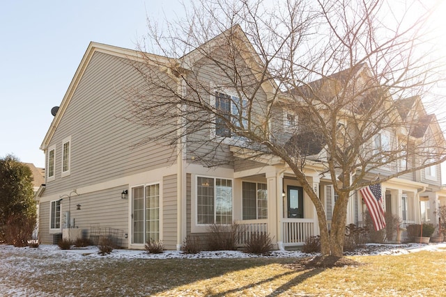 view of snow covered exterior with a yard