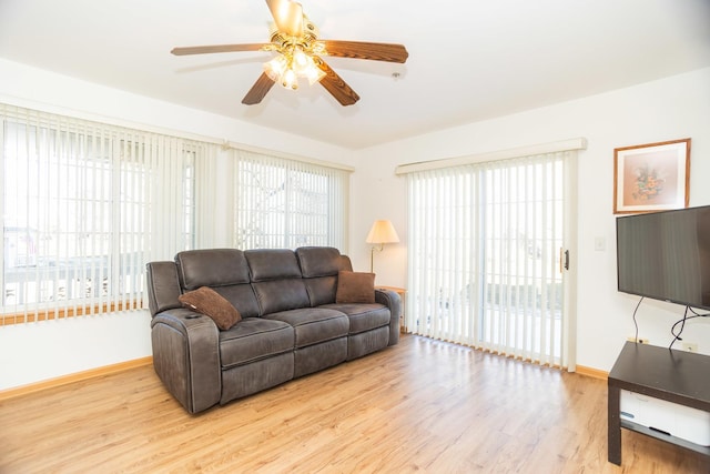 living room featuring light wood-type flooring and ceiling fan