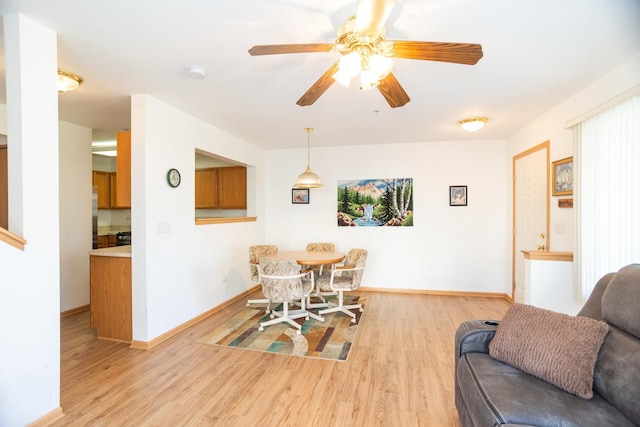 dining room with ceiling fan and light hardwood / wood-style flooring