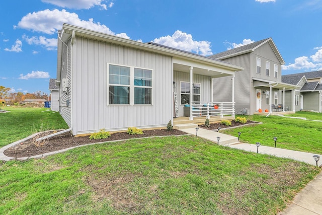 view of front of home featuring covered porch and a front yard