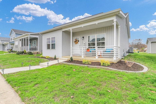 single story home featuring a porch and a front yard