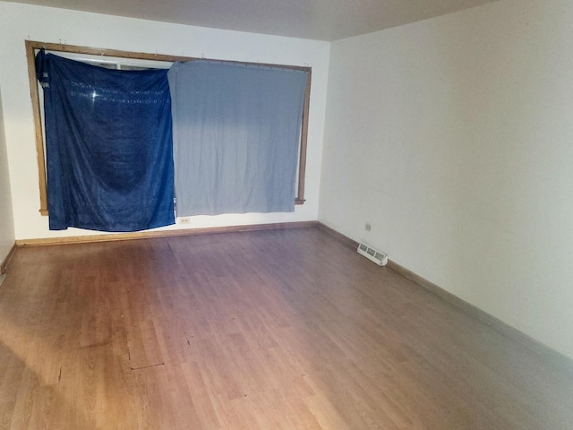 spare room featuring hardwood / wood-style floors