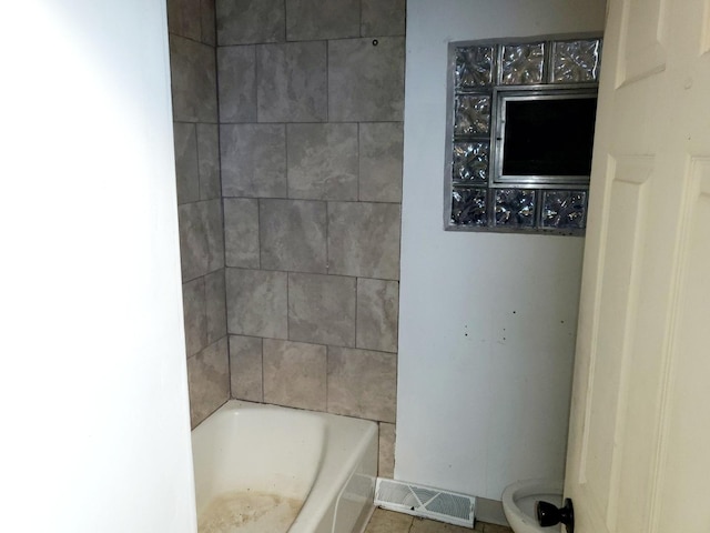 bathroom with toilet and tile patterned flooring