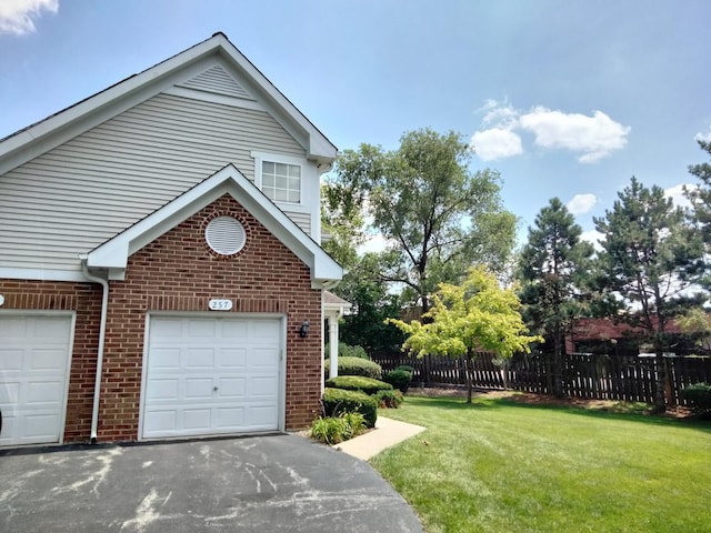 exterior space with a yard and a garage