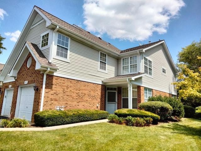 view of front of house with a front yard and a garage