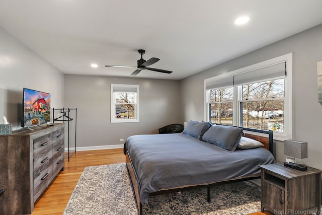 bedroom with ceiling fan and light hardwood / wood-style floors