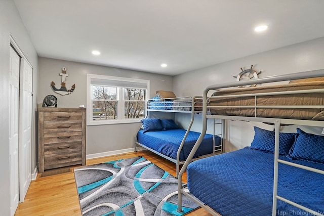 bedroom with hardwood / wood-style flooring and a closet