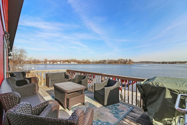 wooden terrace featuring a water view and outdoor lounge area