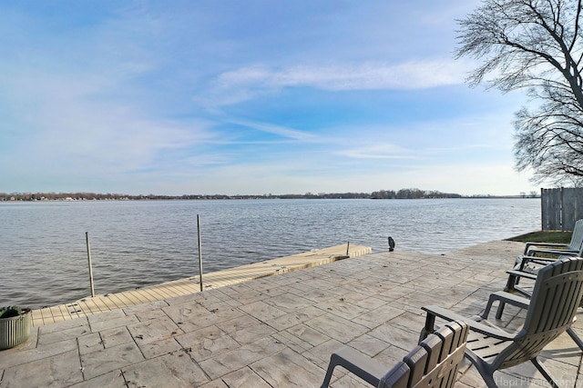 view of patio / terrace with a water view and a boat dock