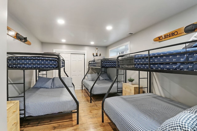 bedroom with hardwood / wood-style floors and a closet