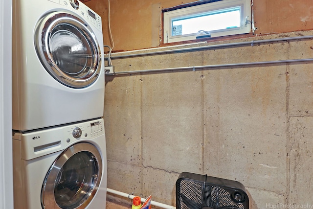 clothes washing area featuring stacked washer / drying machine