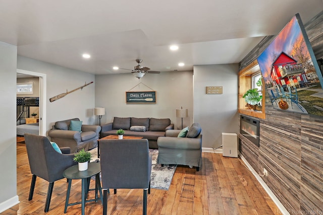 living room featuring ceiling fan and wood-type flooring