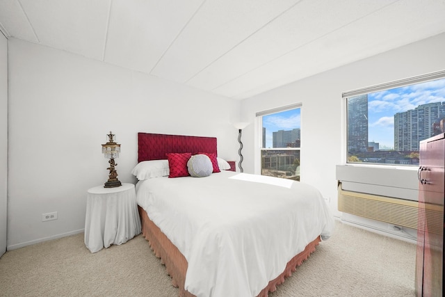 bedroom with light colored carpet and multiple windows