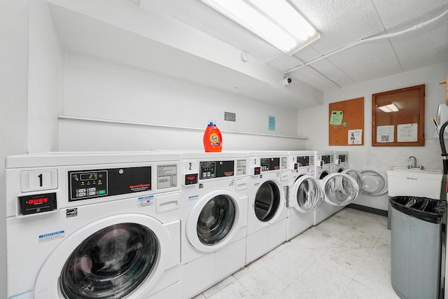 laundry room with washer and dryer and sink