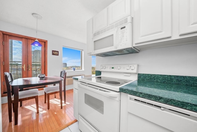 kitchen featuring white appliances, hanging light fixtures, french doors, light tile patterned floors, and white cabinetry